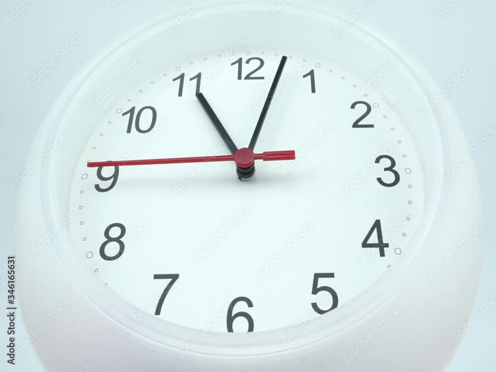 White wall clock isolated on white background, face beginning of time 11.03 am or pm, Clock minute walk slowly, Time concept. White wall clock isolated on white background, face beginning of time 11.03 am or pm, Clock minute walk slowly, Time concept.
