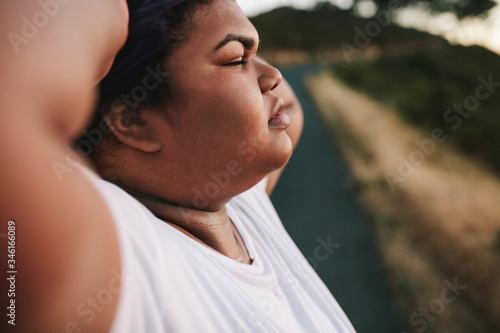Oversized woman tired after exercising outdoors