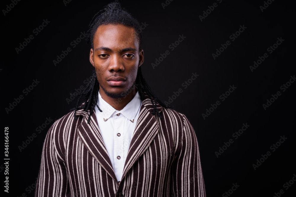 Fototapeta premium Face of young handsome African businessman in suit with dreadlocks