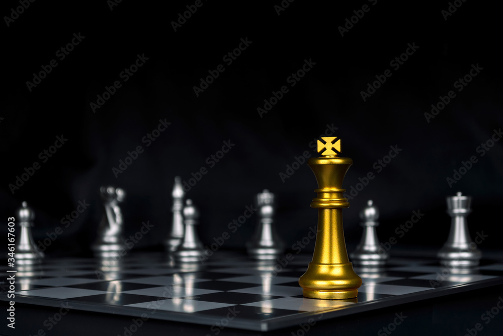 Leader. gold king with silver chess pieces on chess board game competition on dark background, business plan, chess battle, victory, success, team leader, teamwork and business strategy concept Leader. gold king with silver chess pieces on chess board game competition on dark background, business plan, chess battle, victory, success, team leader, teamwork and business strategy concept