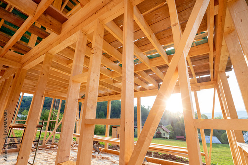 Interior frame of new wooden house under construction © leszekglasner