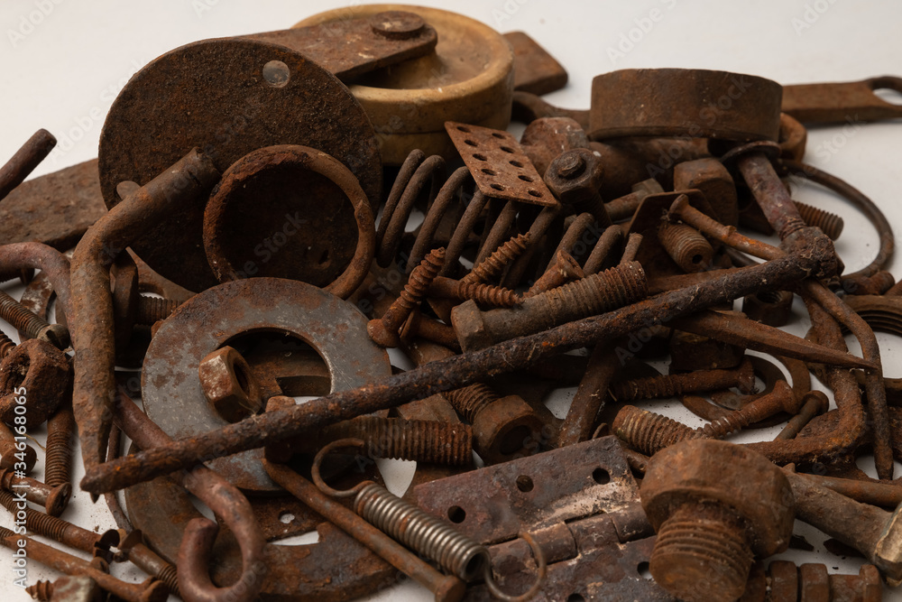a mountain of various rusty metal construction parts on a white background a mountain of various rusty metal construction parts on a white background