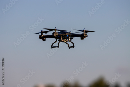 Fototapeta Naklejka Na Ścianę i Meble -  Flying Drone with camera against blue sky close up