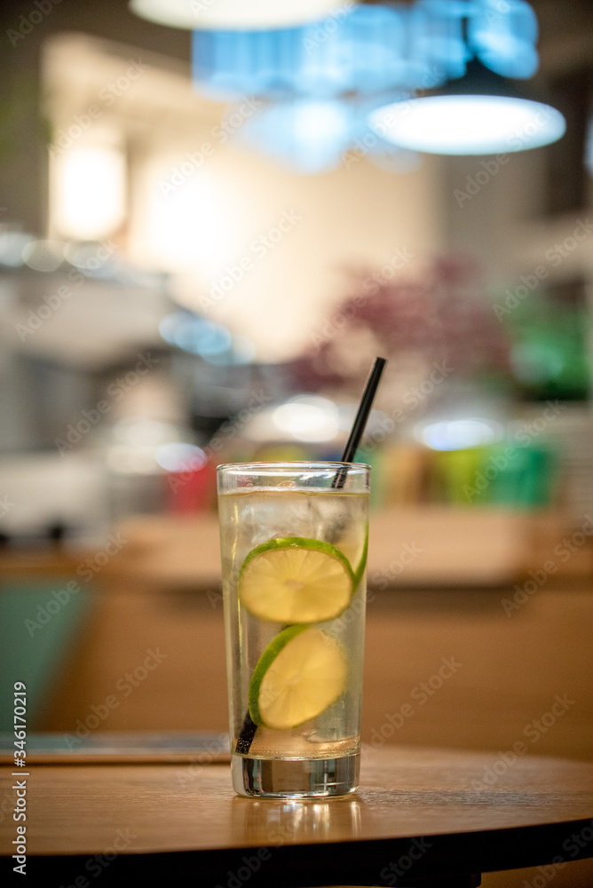 Glass lemonade lime coctail cold drinks fresh fruits table cafe restaurant bokeh Glass lemonade lime coctail cold drinks fresh fruits table cafe restaurant bokeh