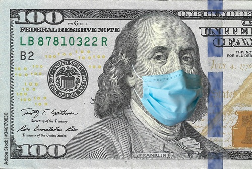 COVID-19, sars-cov-2 coronavirus pandemic going to a financial crush, one hundred dollars USA bill with Benjamin Franklin wearing a protective mask