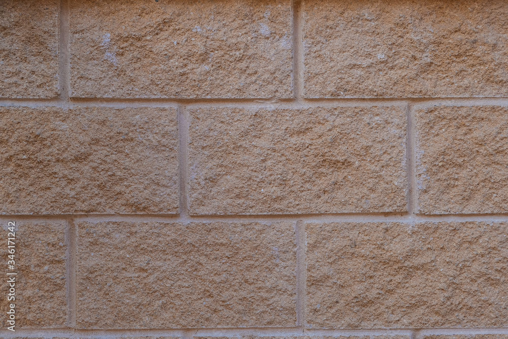 Obraz premium Orange stone wall: outdoor background
