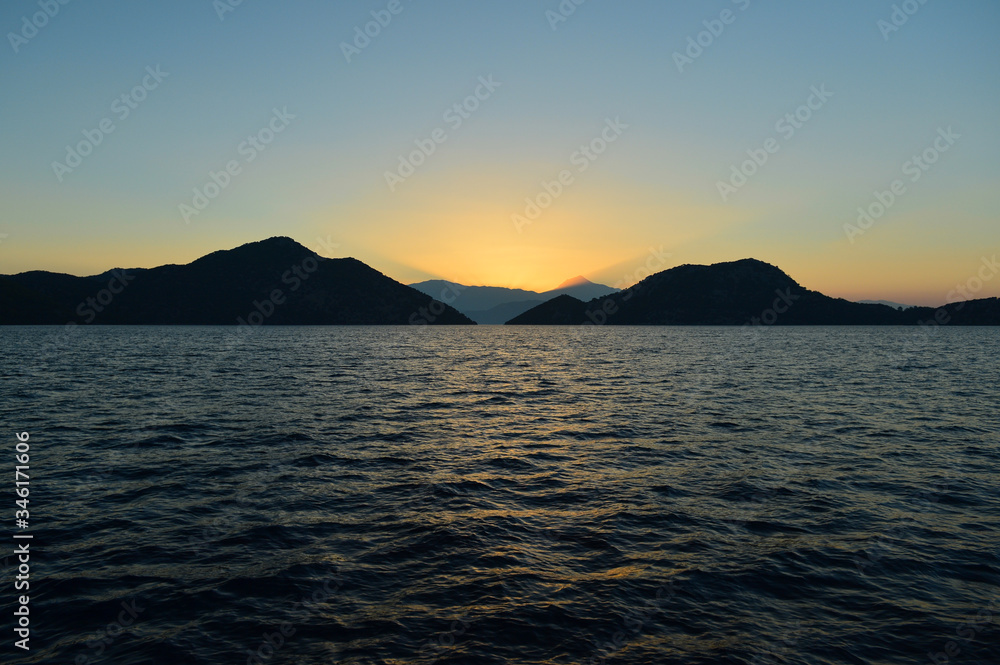 Sunrise in the Mediterranean Sea; ray of sun direct to sky