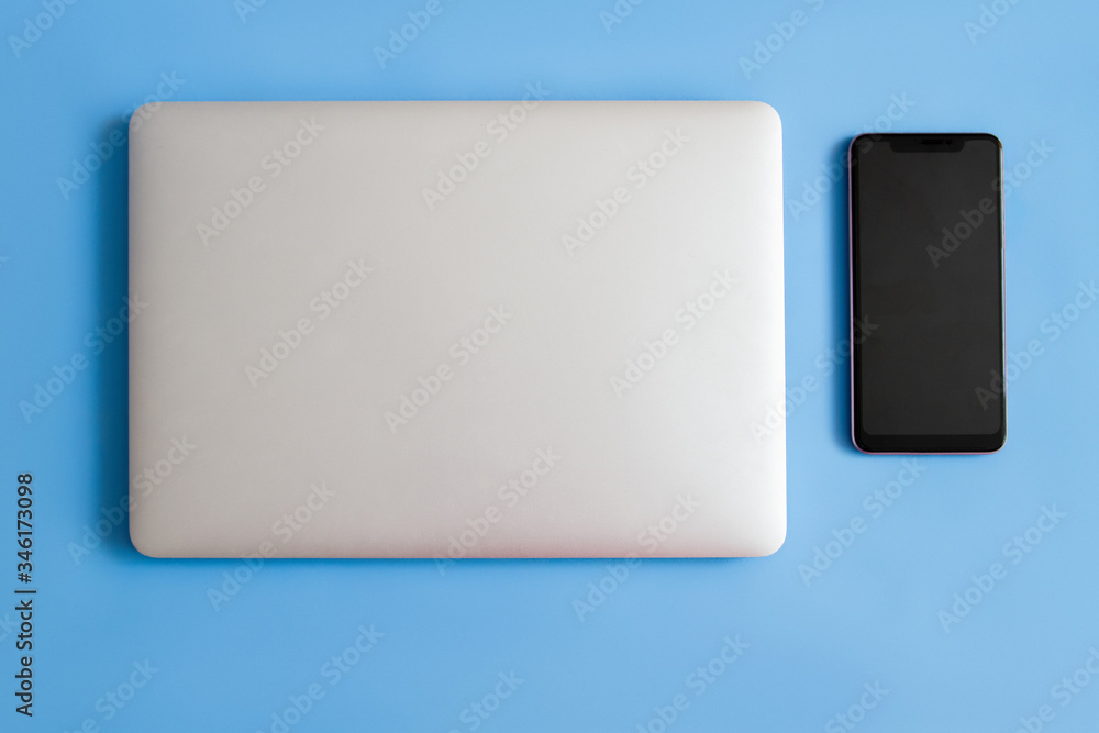 Laptop on a blue background. Laptop and bottle on a blue background. Laptop phone and notepad on a blue background. Laptop phone, notepad and bottle on a blue background, background, blank, book, bran Laptop on a blue background. Laptop and bottle on a blue background. Laptop phone and notepad on a blue background. Laptop phone, notepad and bottle on a blue background, background, blank, book, bran