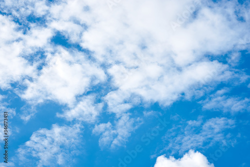 Light blue sky with white clouds. Nature protection concept. Sunny day  warm weather.