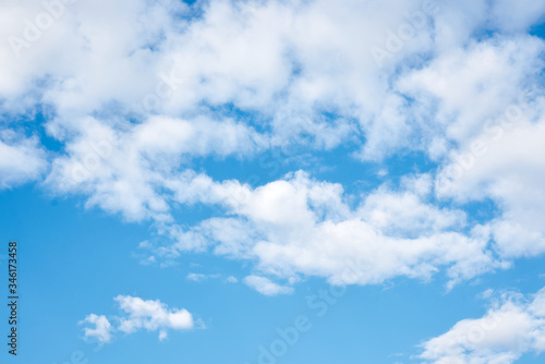 Light blue sky with white clouds. Nature protection concept. Sunny day, warm weather. © Natalia