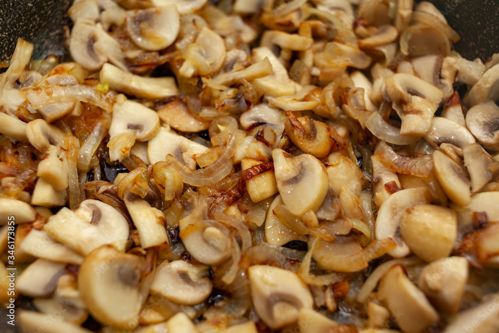 Fried mushrooms with onions top view Fried mushrooms with onions top view