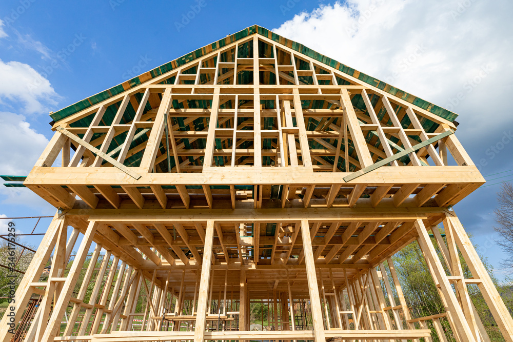 New wooden frame house under construction, outdoor residential home New wooden frame house under construction, outdoor residential home