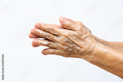 Blurred Senior woman's hands washing her hands using soap foam in step 1 on white background, Close up & Macro shot, Prevention from covid19, Bacteria, healthcare concept, 7 step wash hand