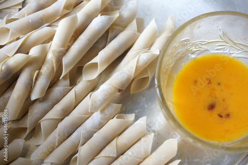 The process of making or cooking an kacang sembunyi (Indonesian). Popular snack from indonesia. Beans wrapped in a dough skin from flour . Deep fried using oil and  liquid sugar.  photo