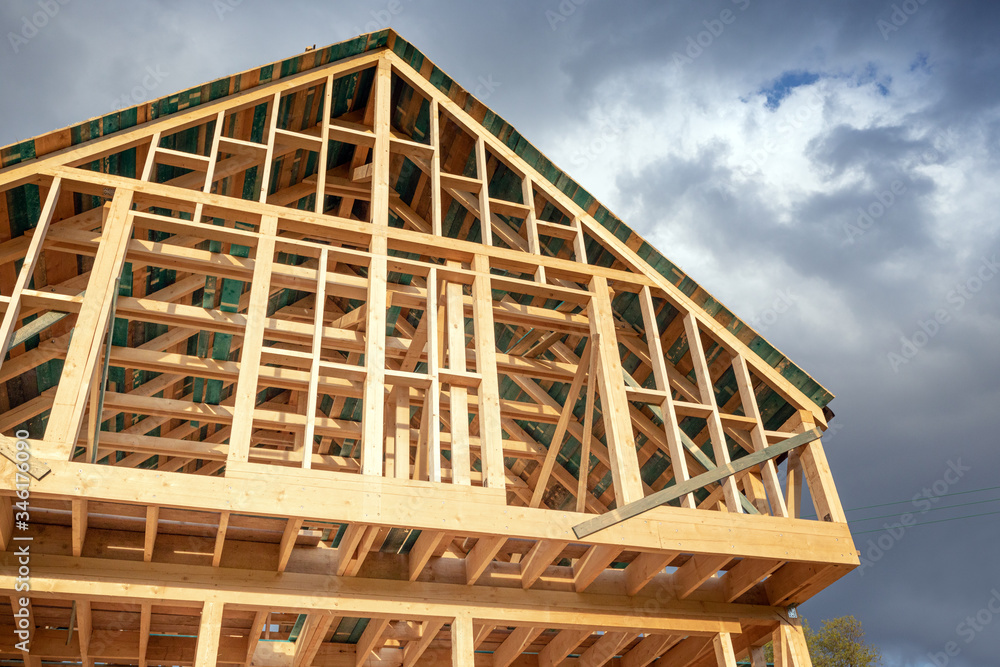 New wooden frame house under construction, outdoor residential home New wooden frame house under construction, outdoor residential home