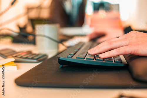 woman typing on a keyboard at the office