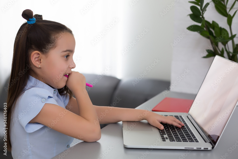 little girl studying with laptop online learning