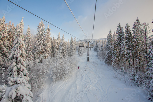 Ski lift in the snow mountains © Mishainik