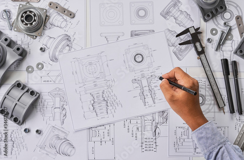 Fotografie Engineer technician designing drawings mechanical parts engineering Engine