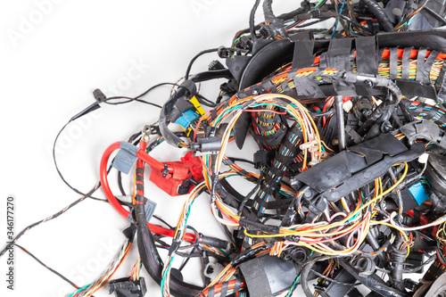 A tangled bunch of wires with connectors of different colors of type and size on a white background. A difficult task for the system administrator when conducting diagnostics of the digital Internet.