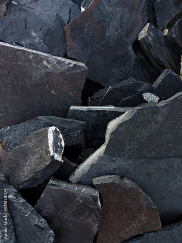 Dark Aged Shabby Cliff Face And Divided By Huge Cracks And Layers. Coarse, Rough Gray Stone Or Rock Texture Of Mountains, Background And Copy Space For Text Rock Shelf for a Product Display