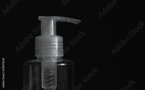 Dispenser bottles with antiseptic on a black background. Bottle of hand sanitizer. Coronavirus disinfectants, Covid19 disinfectants.