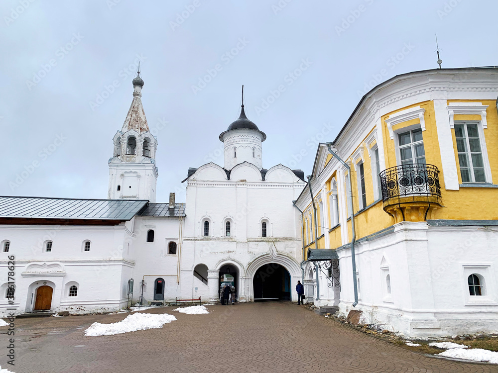 Winter Abbot cells, gate Church of the Ascension with bell tower and summer Abbot cells in the Spaso-Prilutsky monastery in Vologda in winter in cloudy weather. Russia