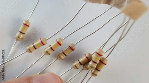 fixed (fixed-value) permanent resistor on a white background. Extreme close-up, real time, low depth of field-contains people