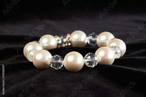 bracelet from pink Mallorca pearls semiprecious stone on black velor. close up