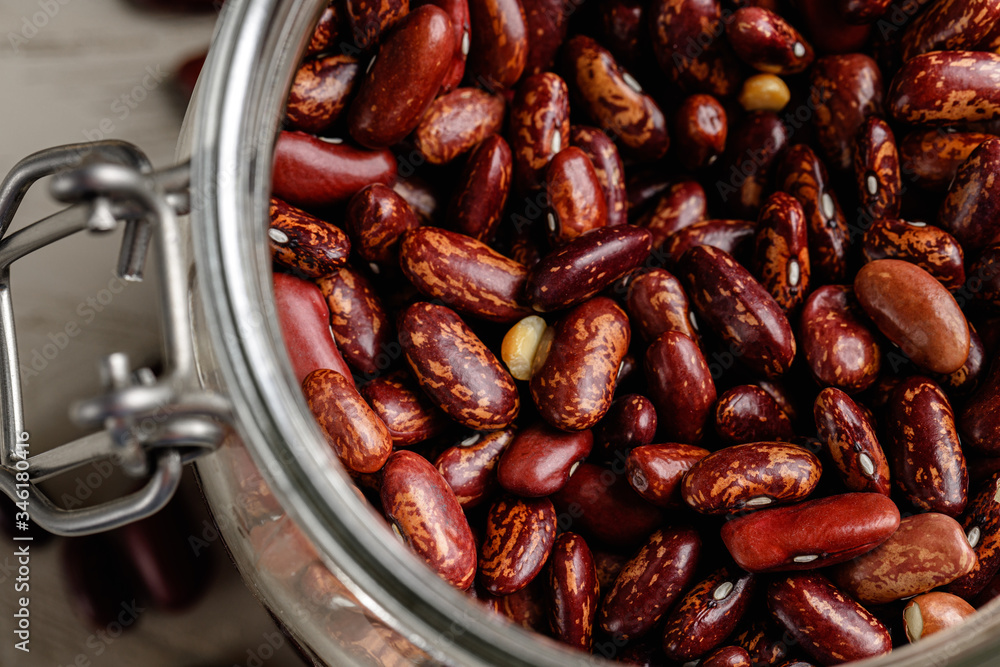 Raw cereals or beans in glass jars close up. Vegan and vegetarian food. Close up. Raw cereals or beans in glass jars close up. Vegan and vegetarian food. Close up.