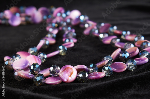 pearl necklace with semi-precious stone on black velor. close up
