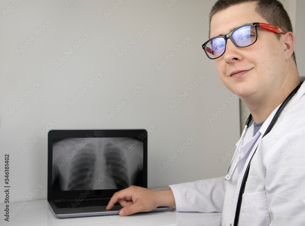 A doctor examines a chest x-ray on a computer monitor. Diagnosis of respiratory diseases