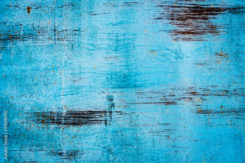 Texture of a rusty metal surface: dark blue, blue, aged cracked paint. Background of old painted sheet metal with rust painted in blue.