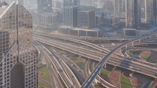 Aerial view of empty highway interchange in Dubai downtown after epidemic lockdown. Cityscapes with appearing traffic on a bridge and streets. Roads and lanes crossroads without cars, Dubai, United photo