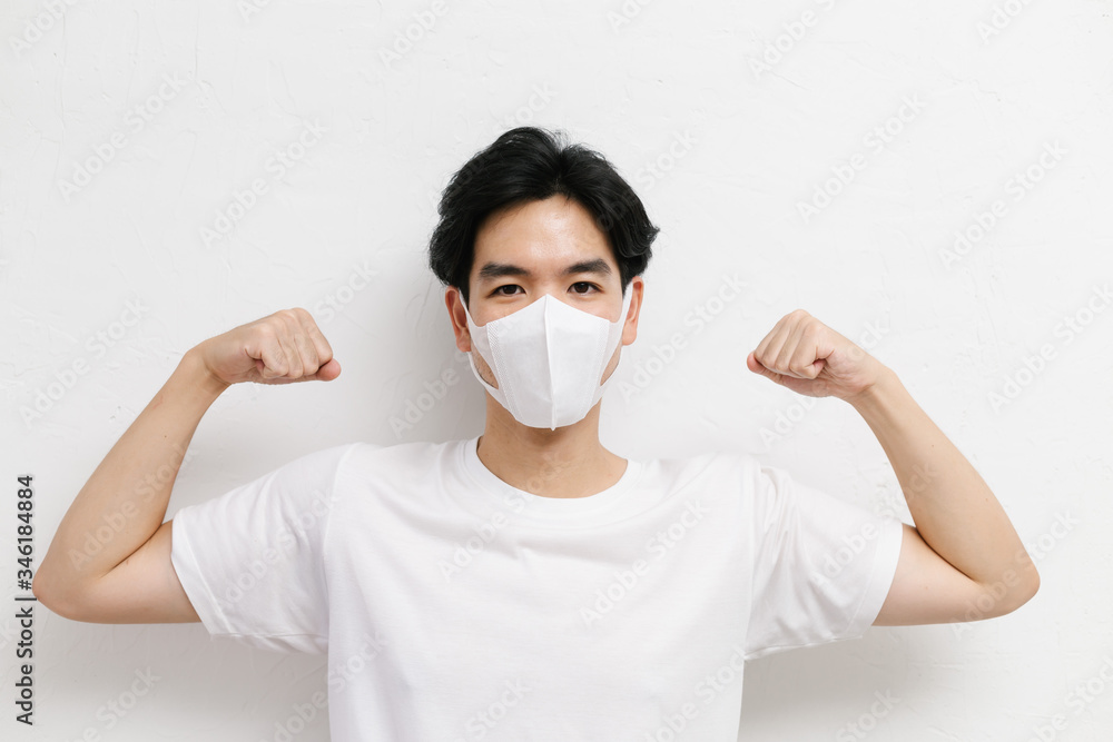 Young asian healthy male wearing medical face mask to protect corona virus, studio portrait. Young asian healthy male wearing medical face mask to protect corona virus, studio portrait.