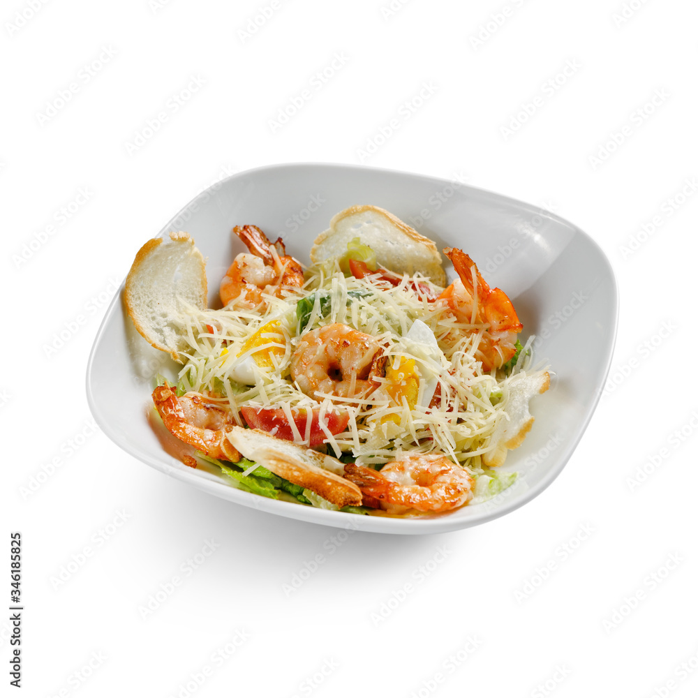 Caesar Salad with grilled shrimps. Isolated on a white background. Caesar Salad with grilled shrimps. Isolated on a white background.