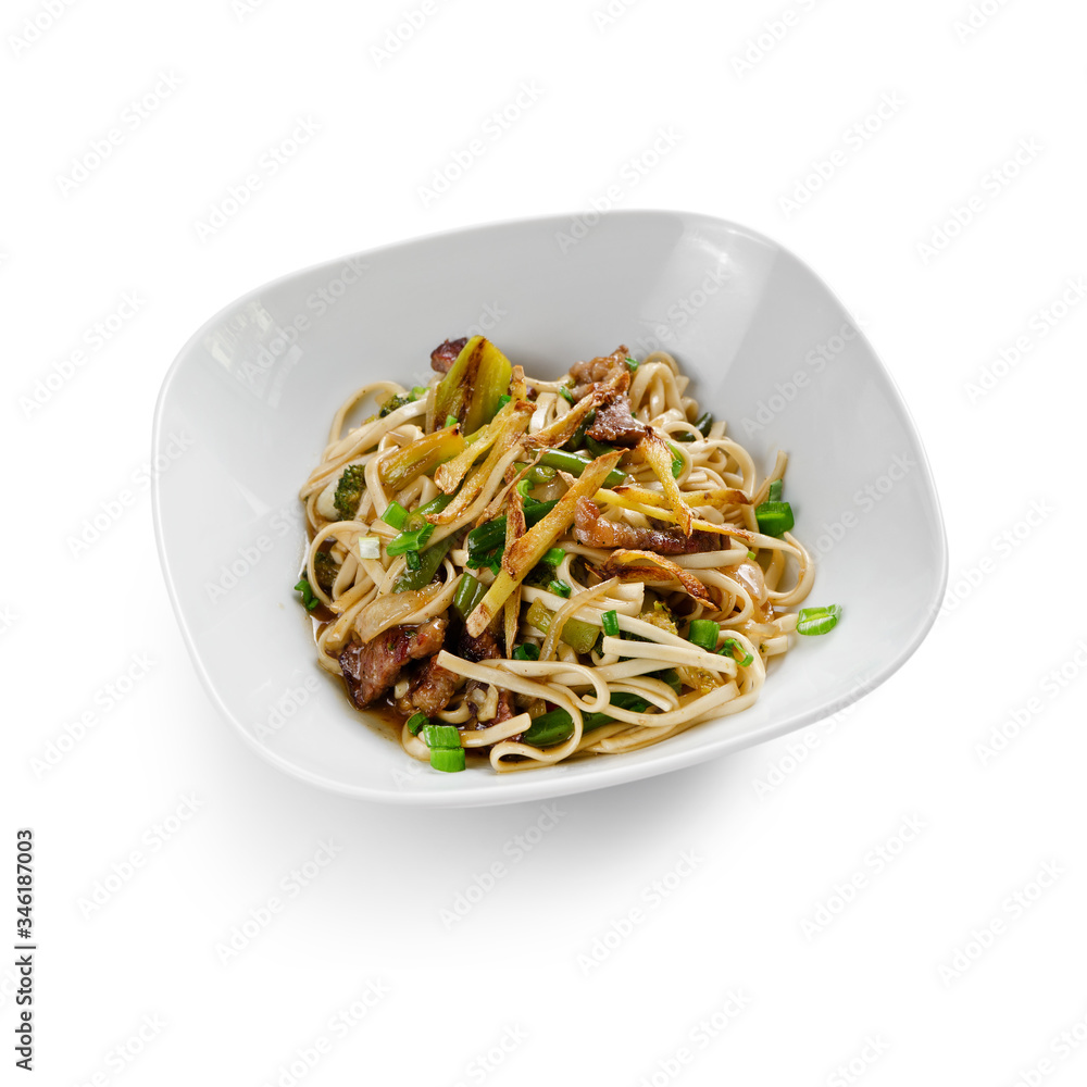 Fried udon noodles in a wok with slices of pork, green beans and bell pepper. Traditional asian food. Isolated on a white background. Fried udon noodles in a wok with slices of pork, green beans and bell pepper. Traditional asian food. Isolated on a white background.