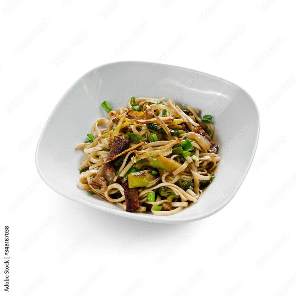 Fried udon noodles in a wok with slices of pork, green beans and bell pepper. Traditional asian food. Isolated on a white background. Fried udon noodles in a wok with slices of pork, green beans and bell pepper. Traditional asian food. Isolated on a white background.