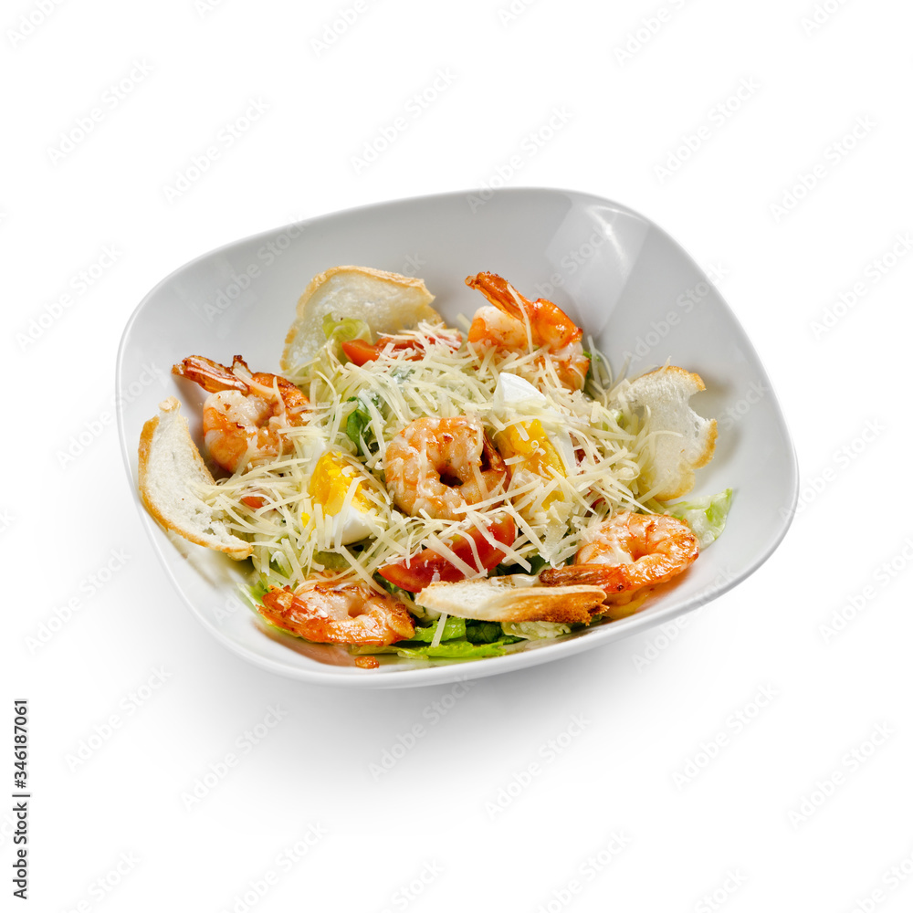 Caesar Salad with grilled shrimps. Isolated on a white background. Caesar Salad with grilled shrimps. Isolated on a white background.