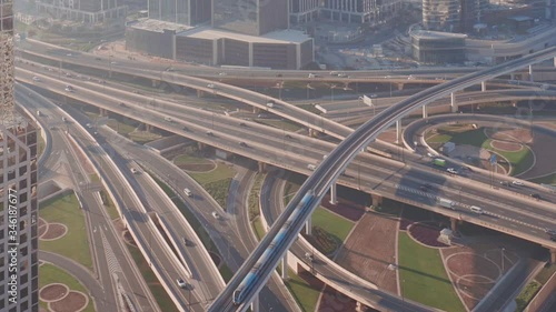 Aerial view of empty highway interchange in Dubai downtown after epidemic lockdown. Cityscapes with appearing traffic on a bridge and streets. Roads and lanes crossroads without cars, Dubai, United photo