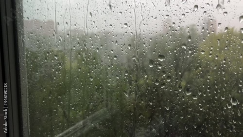 outside the window the heavy rain and strong wind, drops flow down the window