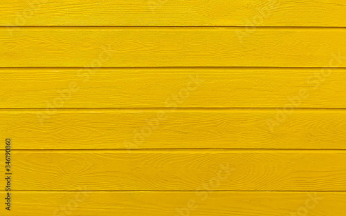 Wooden boards painted in yellow. Yellow wood background.
