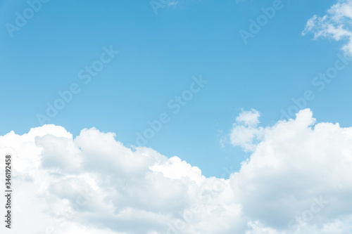 A large white fluffy cloud against a blue sky.