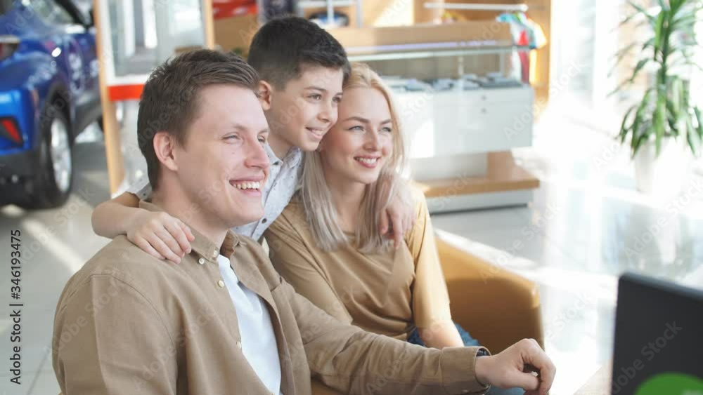 Beautiful caucasian family have conversation with affable pleasant salesman in dealership, get consultation before purchase.