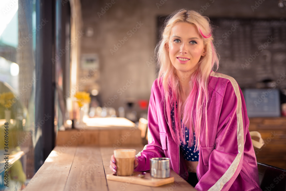 Happy young beautiful blonde woman relaxing at the coffee shop Happy young beautiful blonde woman relaxing at the coffee shop