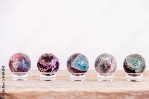 Crystals in the form of balls on a wooden table. Copy, empty space for text