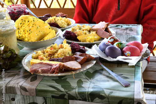 People eating traditional easter food with salad, ham eggs, beetroot and horseradish photo