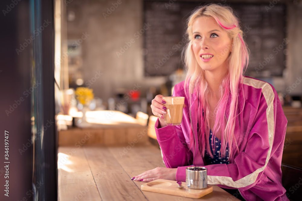 Happy young beautiful blonde woman thinking and relaxing at the coffee shop Happy young beautiful blonde woman thinking and relaxing at the coffee shop