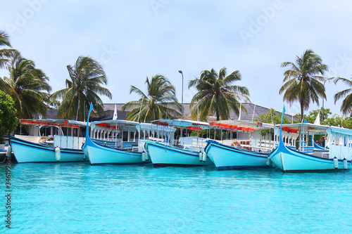 Speed boats or ferry that used as a main transport to bring people to resorts on Maldives islands. Motor boats moored in the local port of Nalaguraidhoo island. The concept of beach holidays