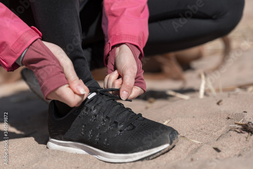 tying shoelaces on sneakers. Girl prepares for sports running